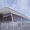 Modern Sales Office Building With Glass Facade And Unique Architectural Design By Water