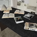 Open Books and Stacked Magazines on Dark Wooden Table with Various Covers