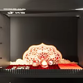 Traditional Decorative Display Area With Red Backdrop Fan And Wall Artworks