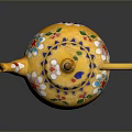 Decorative Yellow Teapot With Vibrant Floral Patterns And Golden Handle Spout