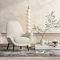 Beige Textured Armchair With Black Legs White Round Floor Lamp Green Plant And Light Wall