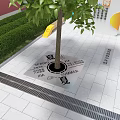 Decorative Tree Pit With Seasonal Inscriptions And Green Shrubs On Paved Ground