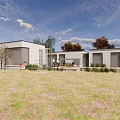 Modern Sales Office Building With Lawn Trees And Blue Sky View