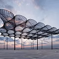 Modern Pergola With Net-like Metal Frame Against Sunset Sky And Open Space