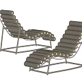 Modern Lounge Chair With Black Metal Frame And Gray Padded Rolls