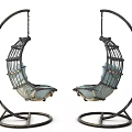 Two Modern Hanging Chairs With Metal Frame Curved Design And Light Blue Cushions