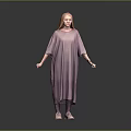 Woman With Red Hair Wearing Loose Purple Dress Standing On Gray Background
