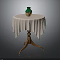 Round Wooden Table With White Fringed Tablecloth And Green Beige Vase