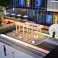 Bustling Modern Commercial Street With Glass Facades Pedestrians Green Plants And Art Sculptures