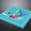 Assorted Household Stationery On Blue Tray With Thumbtacks Crayons And Paper Clip