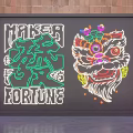 Decorative Neon Lighting With Lion Head Design And Makers Fortune Lettering On Brick Wall