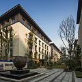Modern Multistory Residential Exterior With Green Landscape And Leisure Seating Area