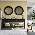 Double Sink Bathroom Vanity With Black Cabinet Two Round Mirrors Yellow Wall And Green Plant