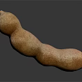 Fresh Ripe Tamarind Fruit with Natural Brown Texture on Dark Surface