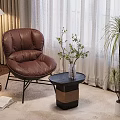 Brown Leather Armchair With Small Round Table Potted Plant Floor Lamp And Rug
