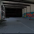 Abandoned Building Interior with Colorful Graffiti Art on Walls Empty Space and Exposed Ceiling Beams