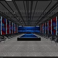 Spacious Indoor Venue With Rows of Chairs Large LED Screen and Central Platform