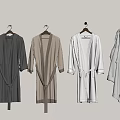 Long Belted Robes In Various Colors Hanging On Light Gray Wall