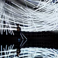 Person Standing In Modern Light Installation With White Linear Beams And Reflection 3d model