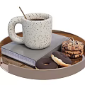 Speckled Ceramic Mug With Coffee And Wooden Spoon On Tray With Book Donuts Tied Cookies
