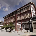 Traditional Commercial Street With Wooden Structure Circular Carved Window And Stone Slab Ground