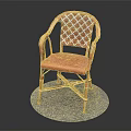 Red Wicker Chair With Patterned Backrest Curved Armrests And Metal Frame On Round Gray Mat