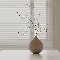 Ceramic Vase Decorated With Twigs And Black Berries On White Table With Window Blinds Background