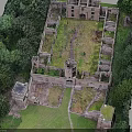 Ancient Castle Ruins Aerial View With Stone Walls And Surrounding Trees