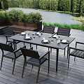 Outdoor Dining Table and Chairs Set on Wooden Deck With Lake View And Green Plants