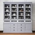 Modern White Sideboard With Glass Doors Displaying Dishes Vases And Plates