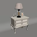 Classic White Bedside Table with Gold Accents Table Lamp Photo Frame and Candle Holders