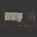 Rustic Clothesline Setup With Wooden Poles Hanging White And Brown Fabrics On Grass Dirt Ground
