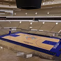 Spacious Basketball Arena Interior With Wooden Court Blue Design And Seating Sections