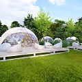 Transparent Geodesic Dome Tents In Green Grass With Trees And White Sofas On Wooden Platform