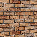 Building Exterior Wall with Rustic Textured Brick Warm Brown and Orange Tones Natural Finish