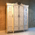 Classic Light Colored Wardrobe With Intricate Carved Patterns And Golden Decorative Trim