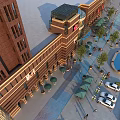 Commercial Street With Red Brick Buildings Outdoor Seating Green Plants Fountain Parking Lot And Vehicles