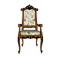 Vintage Carved Wooden Armchair With Floral Fabric Upholstery And Decorative Design