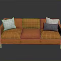 Modern Orange Sofa With White And Blue Cushions And Wooden Legs