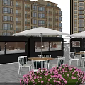 Green Food Truck In Outdoor Dining Area With White Tables Chairs Umbrellas And Menu Board