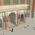 Classical Red Brick Multi Story Building With Large Glass Windows Main Entrance And People Walking
