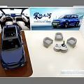 Modern Exhibition Booth Displaying Two Blue Cars With Backdrop And Chairs