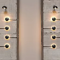 Modern Wall Lamps With Multiple Warm Yellow Bulbs On Textured Concrete Walls