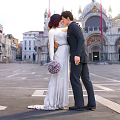 Couple In Wedding Attire Share Romantic Moment In Venice Square