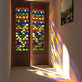Vintage Wooden Double Doors With Stained Glass Panels And Colorful Light Patterns In Interior Hallway