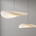 Modern White Pendant Lights with Curved Leaf Shaped Design Hanging Against Gray Wall
