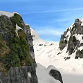 Snow Covered Mountain Landscape With Rocky Cliffs Green Vegetation And Blue Sky