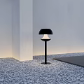 Modern Outdoor Light with Black Pole and White Black Shade on Stone Pavement