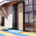 Fun Playground With Colorful Climbing Wall Rope Ladder Glass Walls And Soft Mats For Kids
