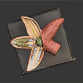 Colorful Decorative Starfish Ornament With Red Yellow Green Petals On Brown Box